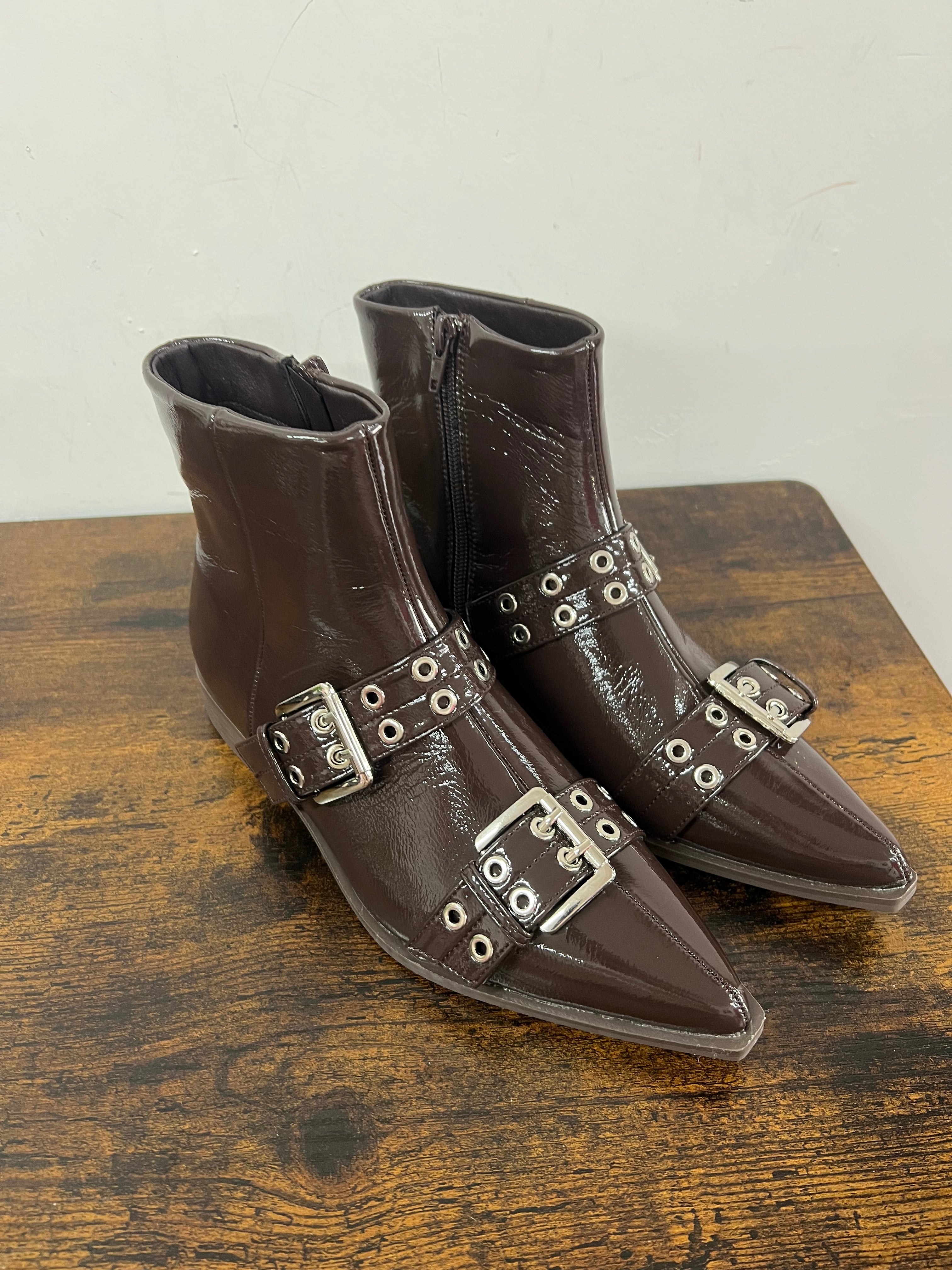 Brown patent leather ankle boots with buckles