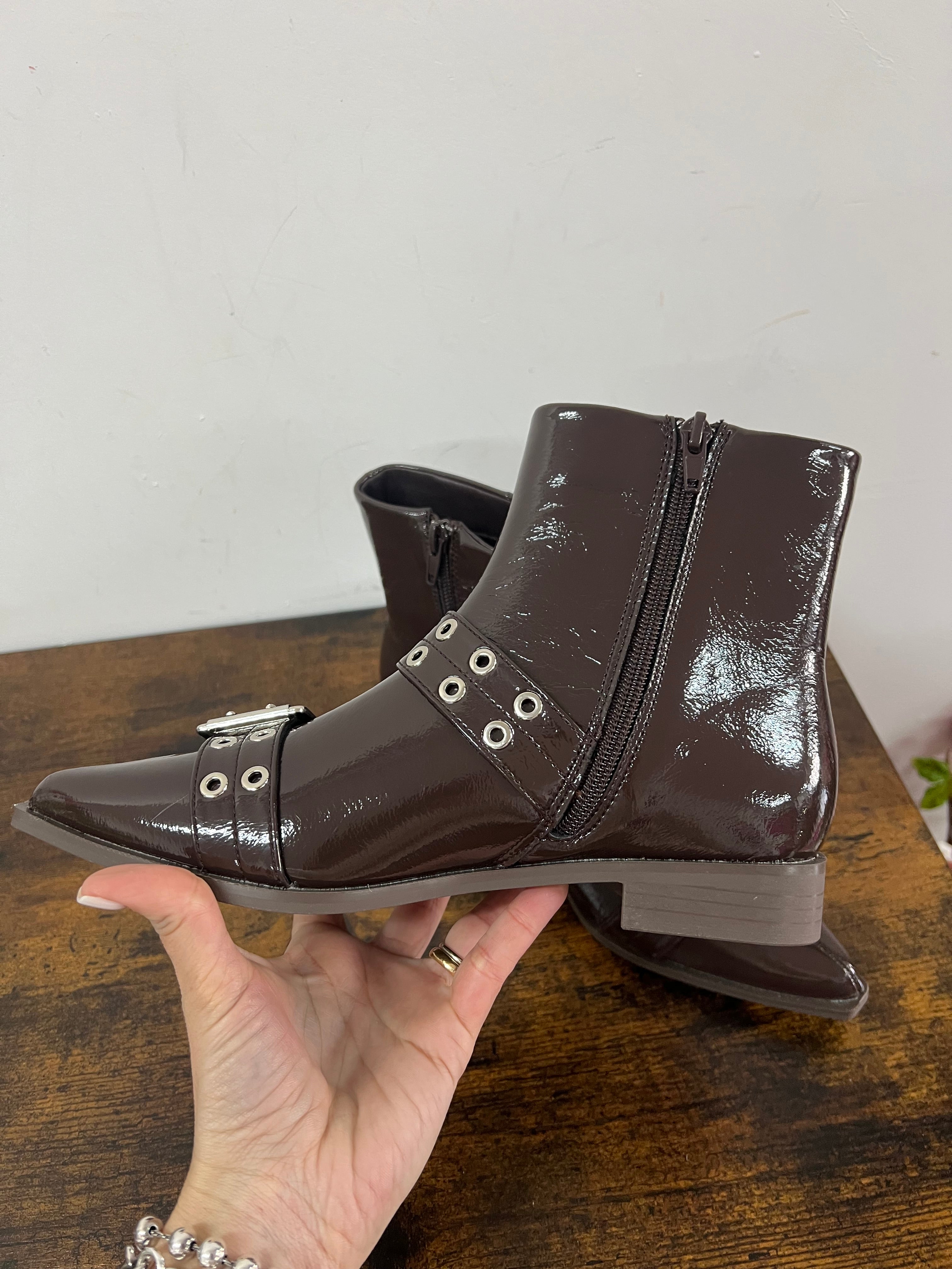 Brown patent leather ankle boots with buckles