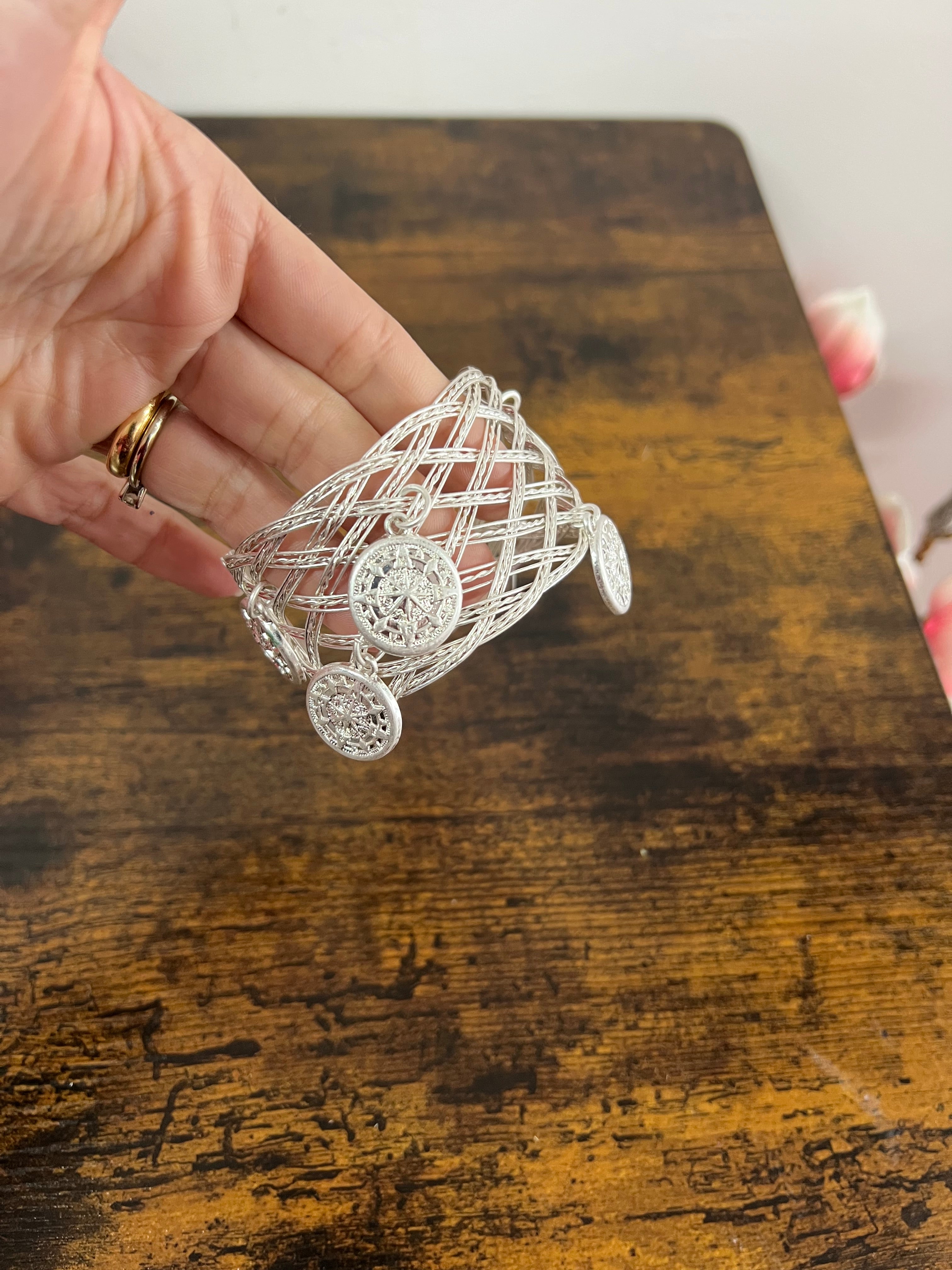 Rigid silver-plated coin bracelet