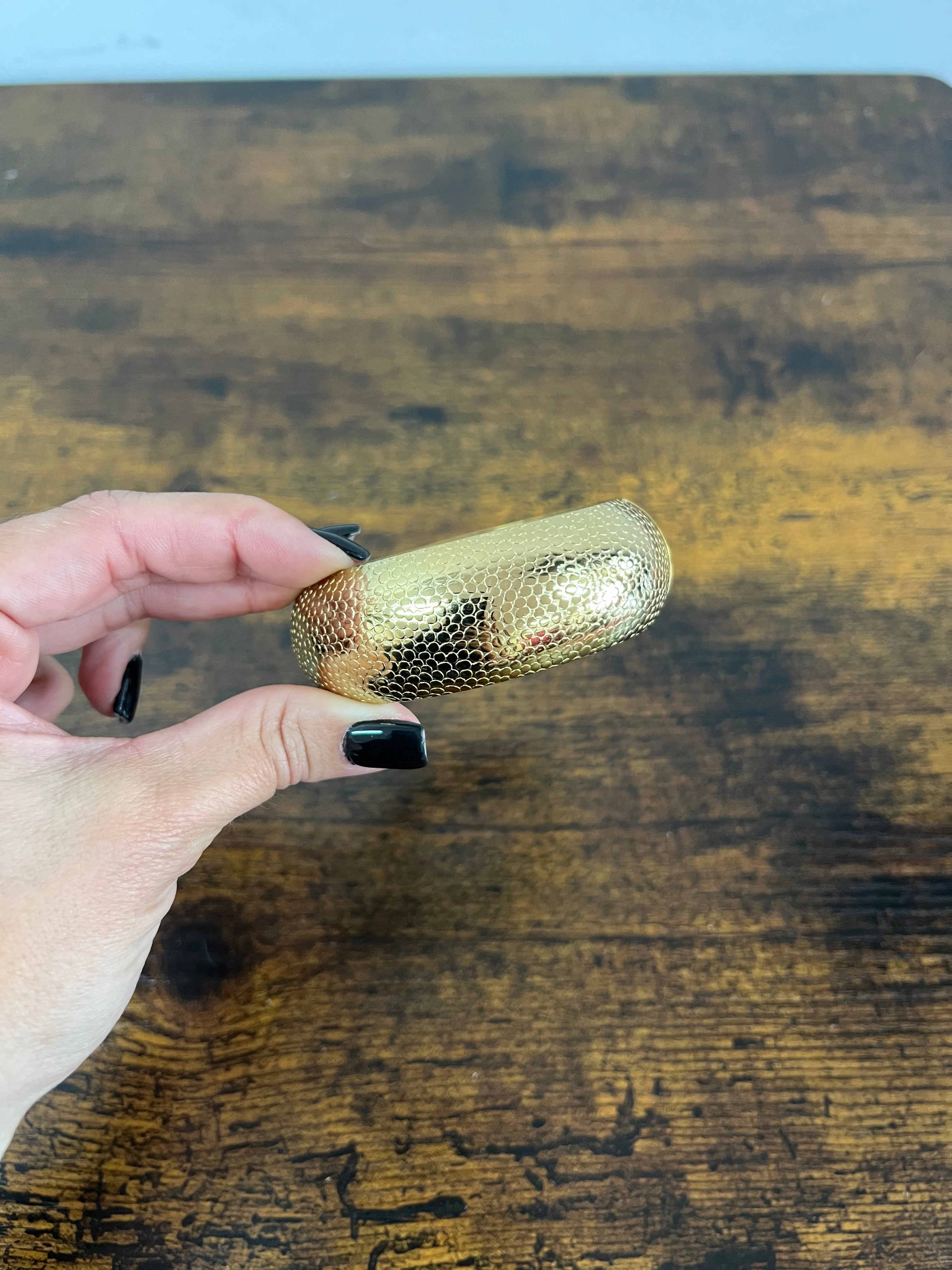 Rigid gilded satin python bracelet